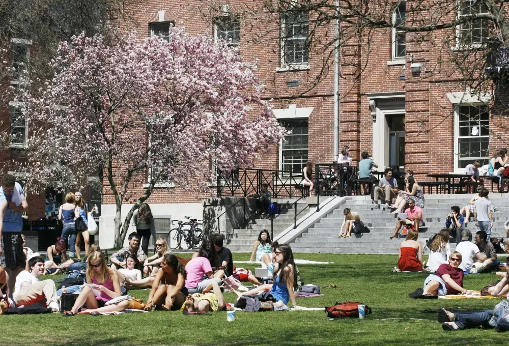 Students relaxing on a campus lawn in spring